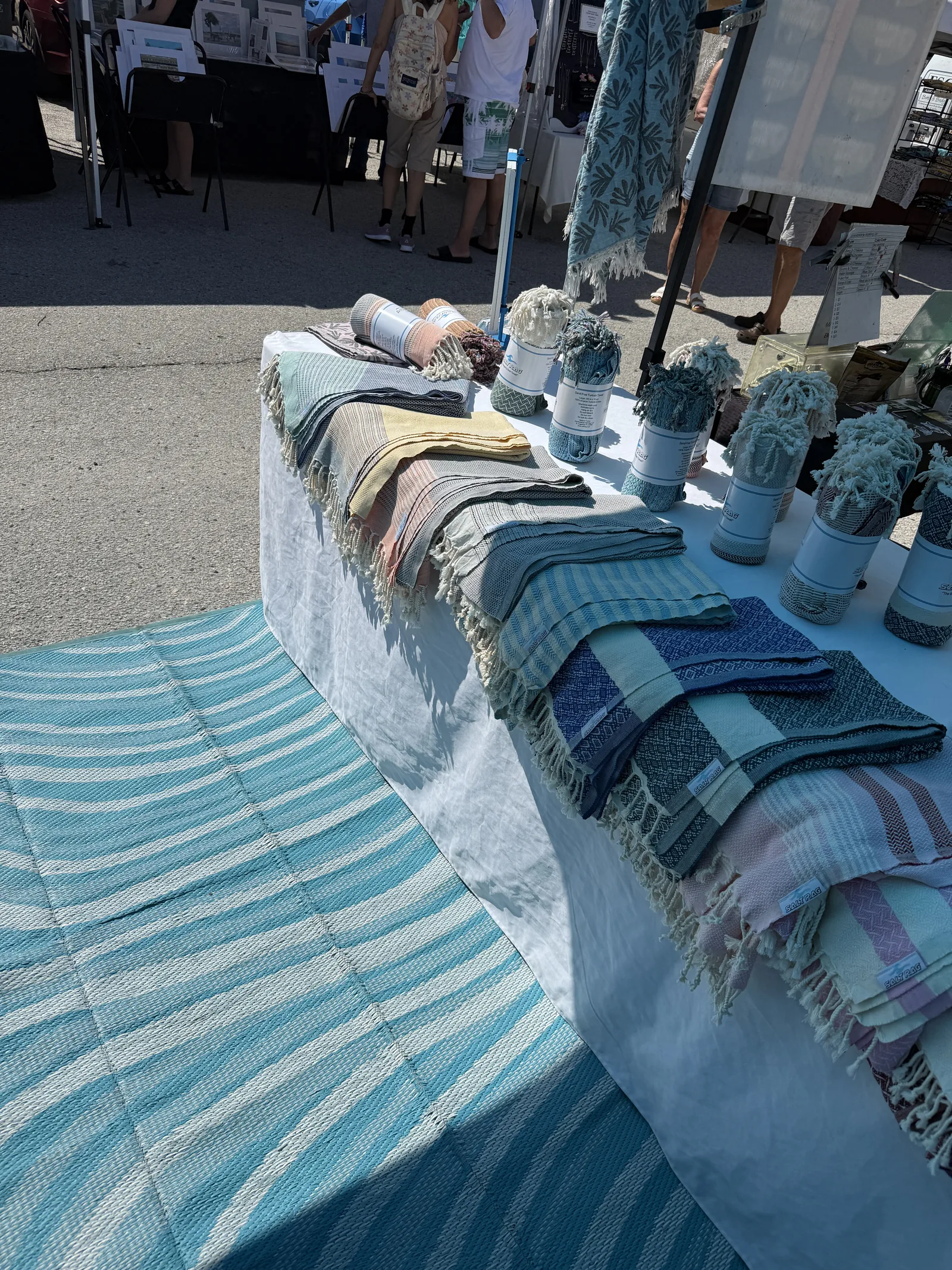 Folded, rolled and draped Salt Rags arranged across an outdoor market display.