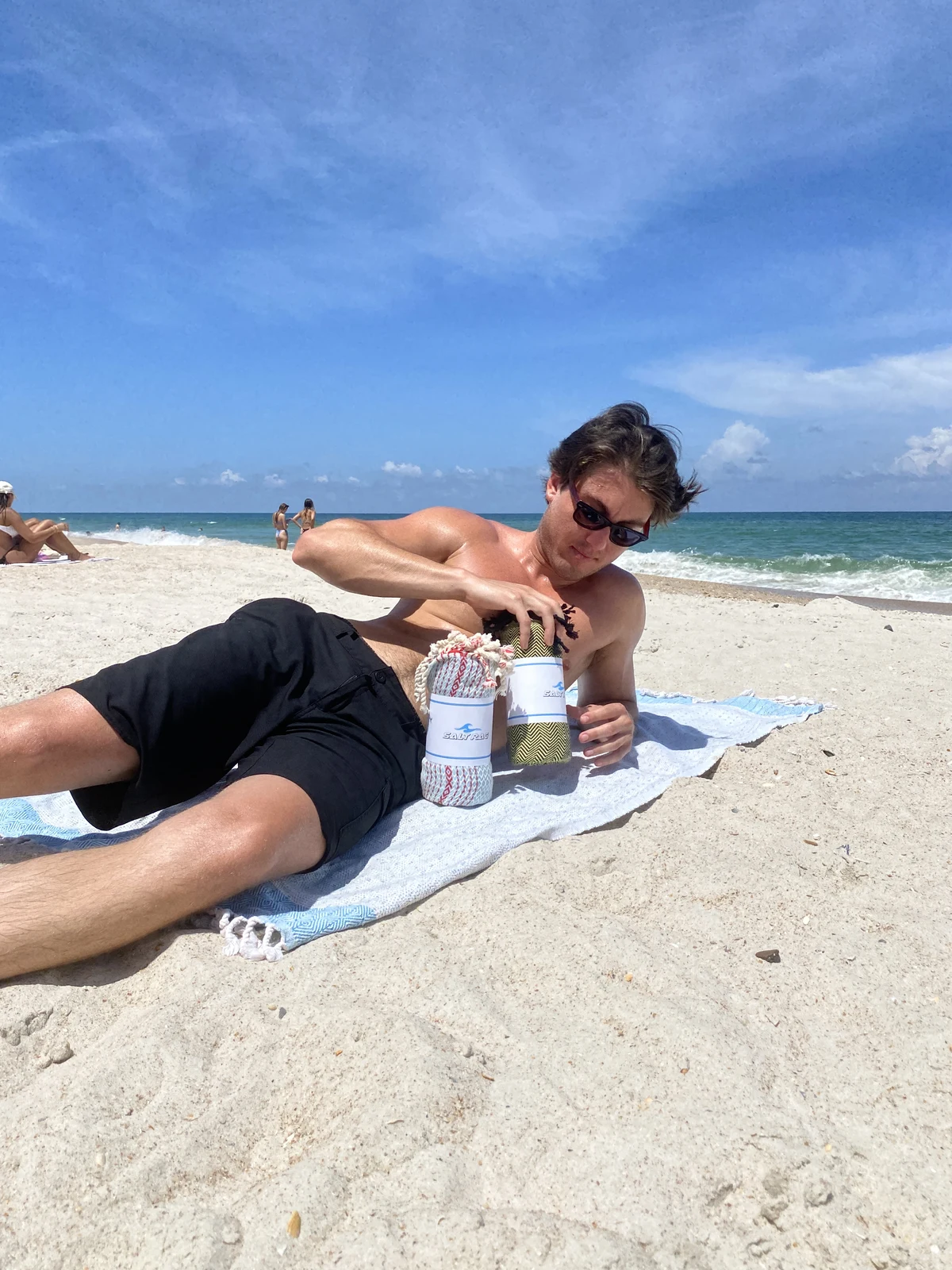 Two people relaxing on Salt Rags at the beach.