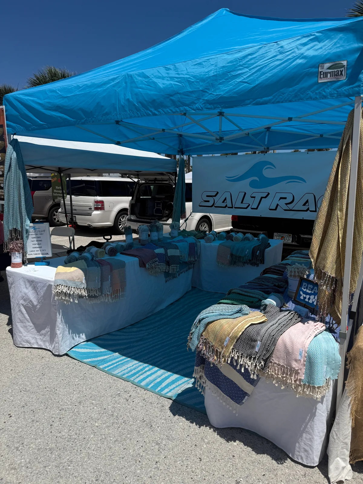 Salt Rag market canopy with folded and draped Rags arranged around the display.
