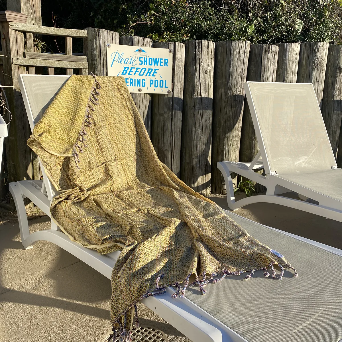 Yellow Salt Rag draped over an outdoor lounge chair.