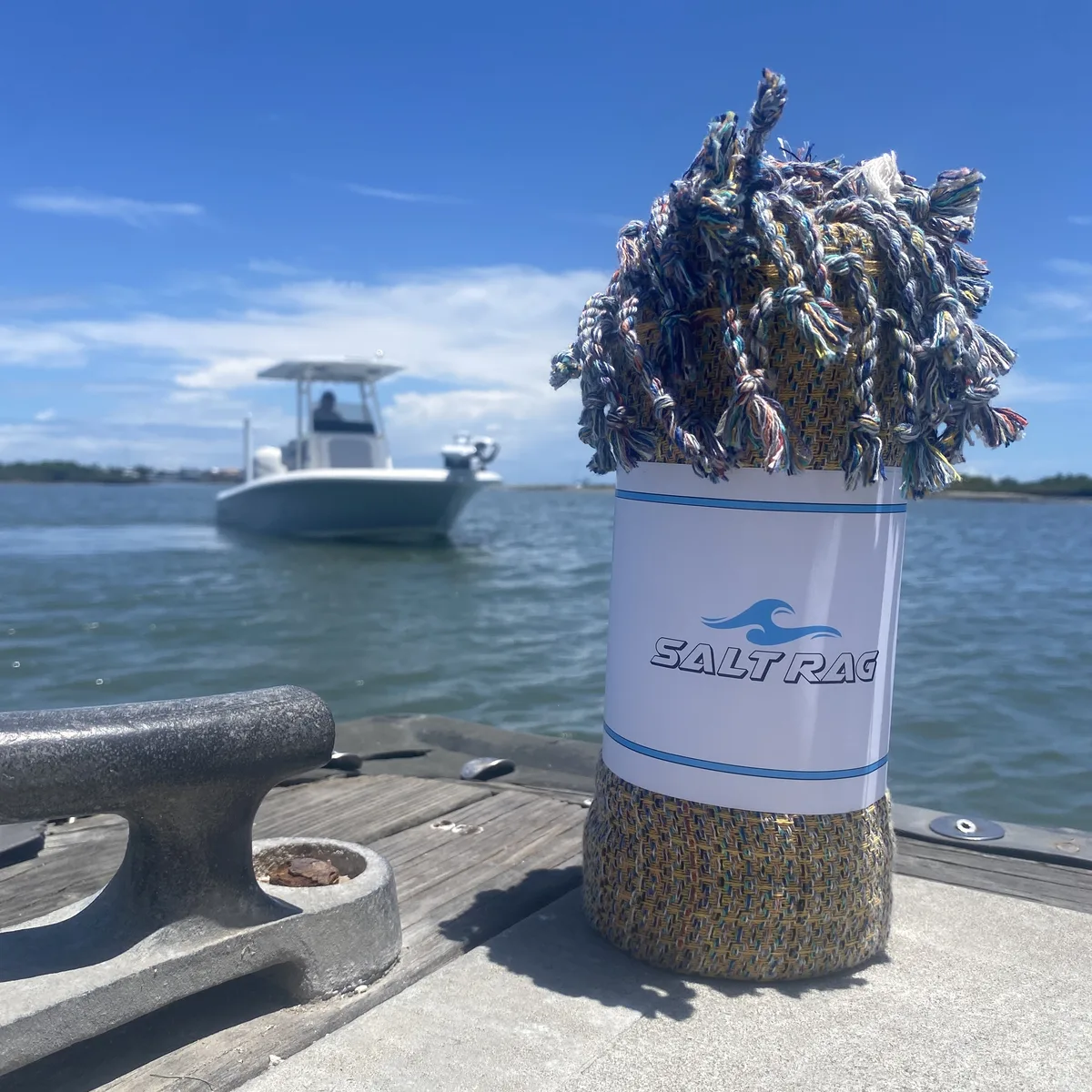 Blue and gold Salt Rag rolled on a boat deck.