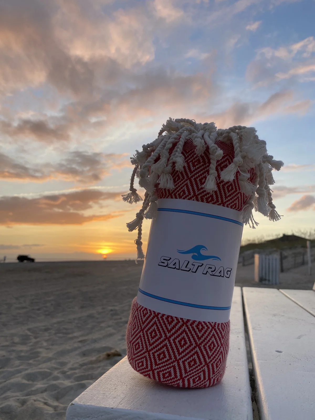 Red rolled Salt Rag against a beach sunset.